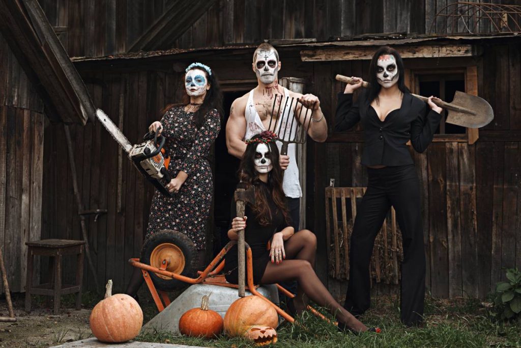 Group of people with sugar skull makeup outdoor. Face painting art.